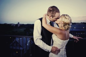 bride-groom-kiss-at-end-of-wedding-reception-night.original