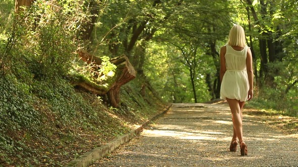 Blonde Girl Walking on a Forest Road preview image